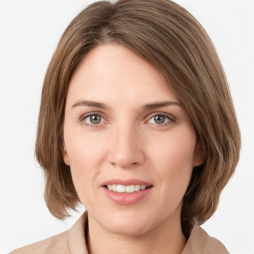 Joyful white young-adult female with medium  brown hair and green eyes