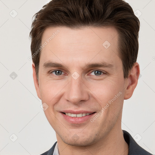 Joyful white young-adult male with short  brown hair and grey eyes