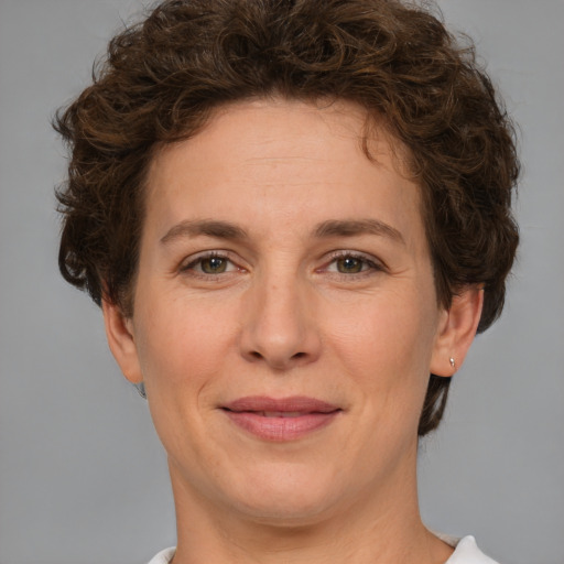 Joyful white adult female with short  brown hair and brown eyes