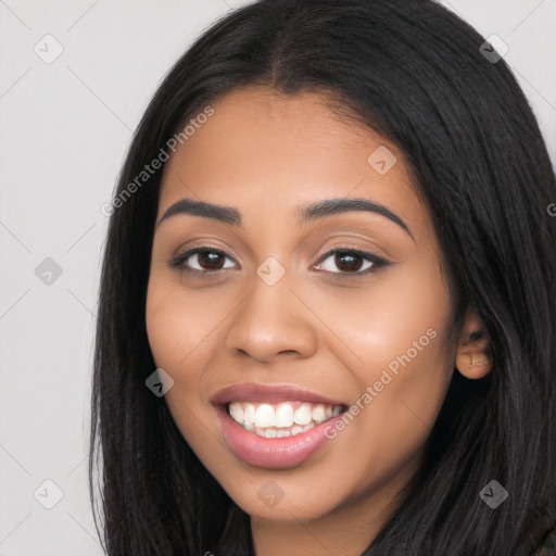 Joyful latino young-adult female with long  black hair and brown eyes