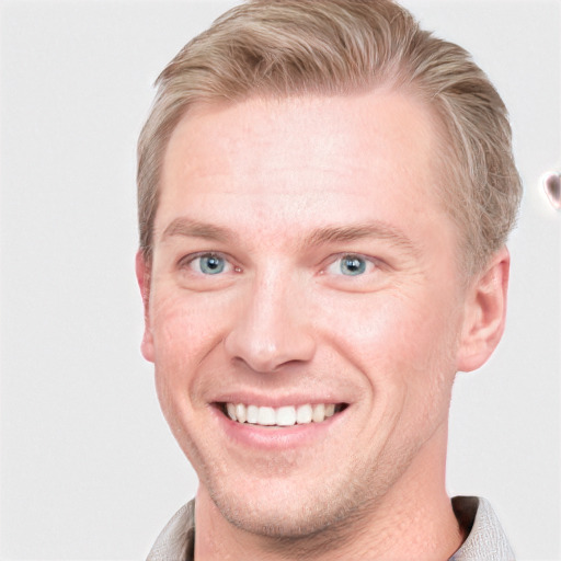 Joyful white young-adult male with short  brown hair and blue eyes