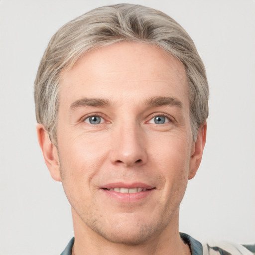 Joyful white adult male with short  brown hair and grey eyes