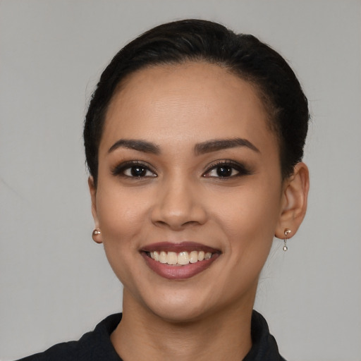 Joyful latino young-adult female with short  black hair and brown eyes