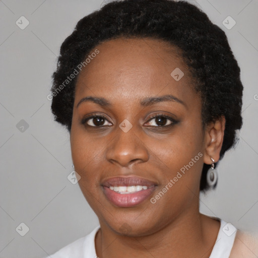 Joyful black young-adult female with short  black hair and brown eyes