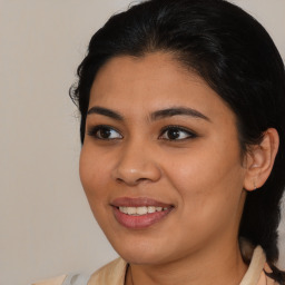 Joyful latino young-adult female with medium  brown hair and brown eyes