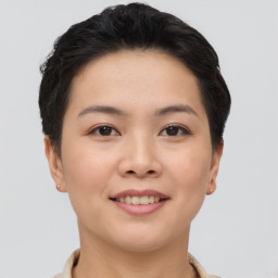 Joyful asian young-adult female with short  brown hair and brown eyes