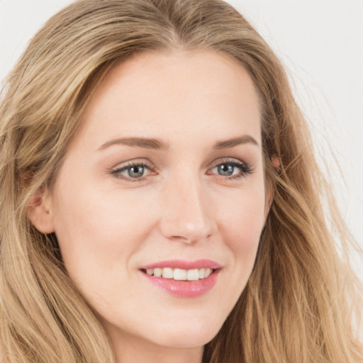 Joyful white young-adult female with long  brown hair and blue eyes