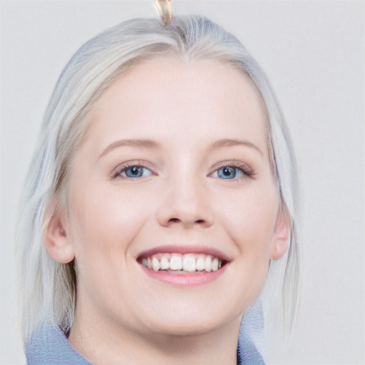 Joyful white young-adult female with medium  blond hair and blue eyes