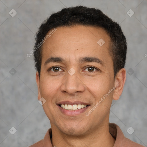 Joyful latino adult male with short  brown hair and brown eyes