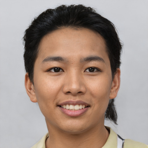 Joyful latino young-adult male with short  black hair and brown eyes