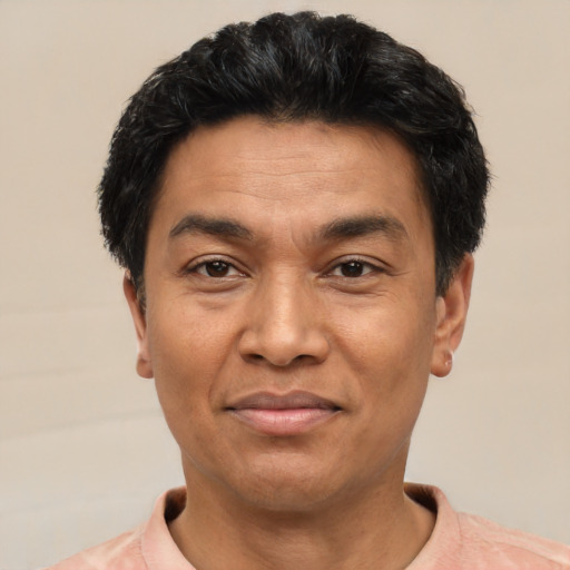 Joyful asian adult male with short  black hair and brown eyes