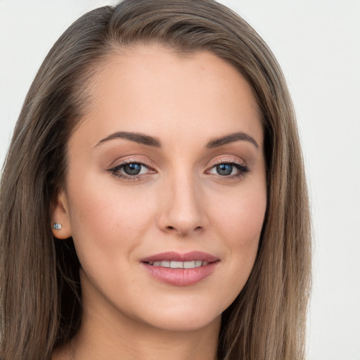 Joyful white young-adult female with long  brown hair and grey eyes