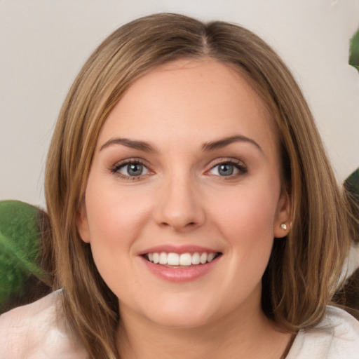 Joyful white young-adult female with medium  brown hair and green eyes