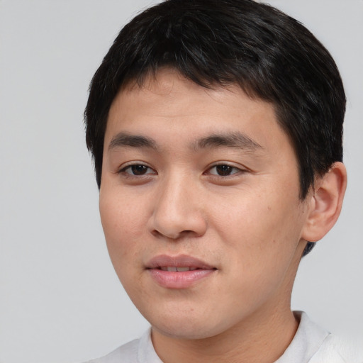 Joyful white young-adult male with short  black hair and brown eyes