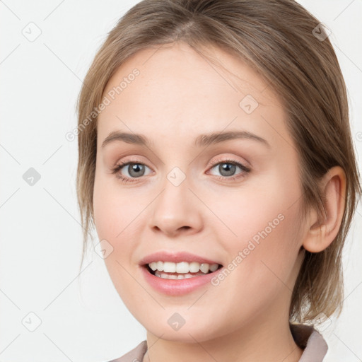 Joyful white young-adult female with medium  brown hair and blue eyes