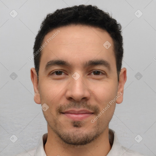 Joyful white young-adult male with short  black hair and brown eyes