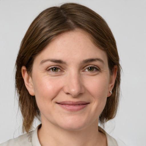 Joyful white young-adult female with medium  brown hair and grey eyes