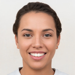 Joyful white young-adult female with short  brown hair and brown eyes