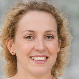 Joyful white young-adult female with medium  brown hair and blue eyes