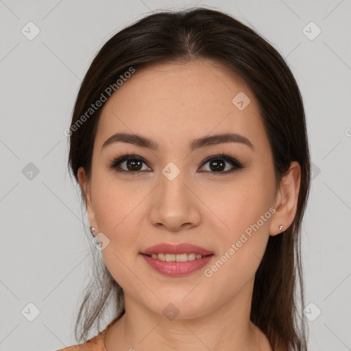 Joyful latino young-adult female with medium  brown hair and brown eyes