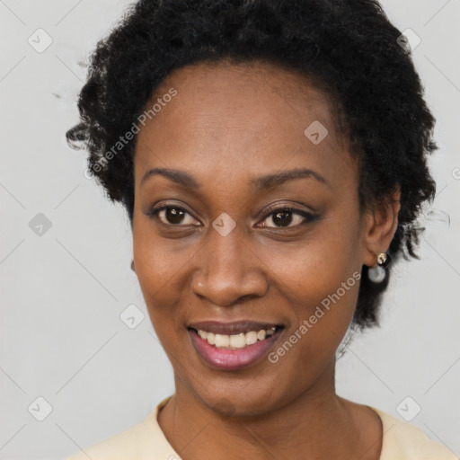 Joyful black adult female with short  black hair and brown eyes