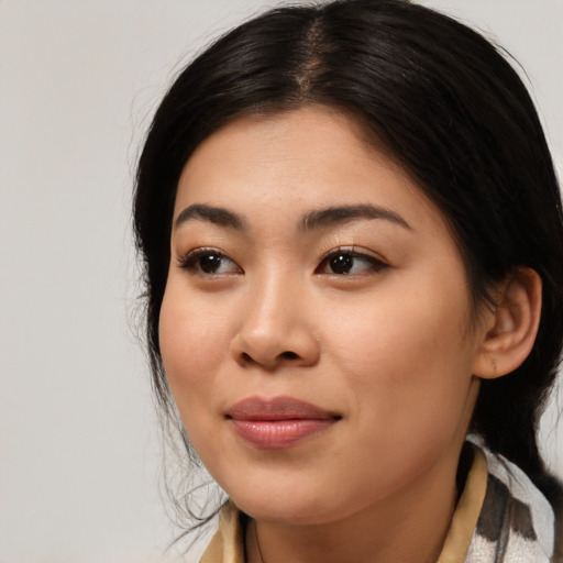 Joyful asian young-adult female with medium  black hair and brown eyes