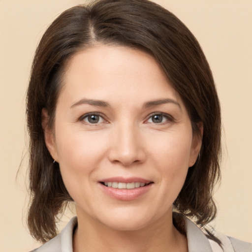 Joyful white young-adult female with medium  brown hair and brown eyes