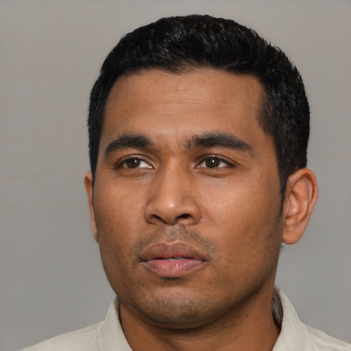 Neutral latino young-adult male with short  black hair and brown eyes