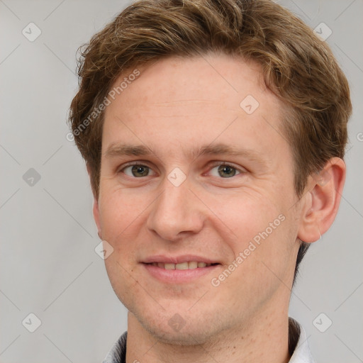 Joyful white adult male with short  brown hair and grey eyes