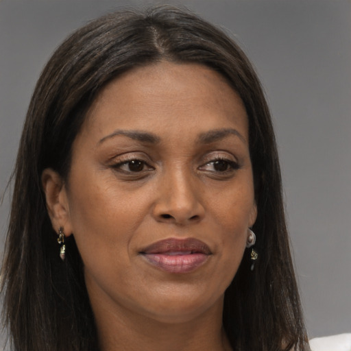 Joyful black young-adult female with long  brown hair and brown eyes