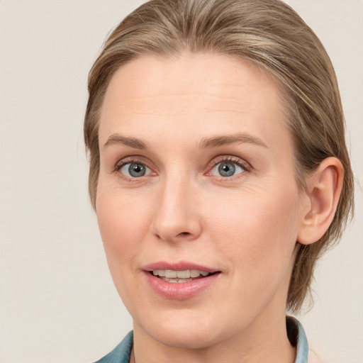 Joyful white young-adult female with medium  brown hair and blue eyes