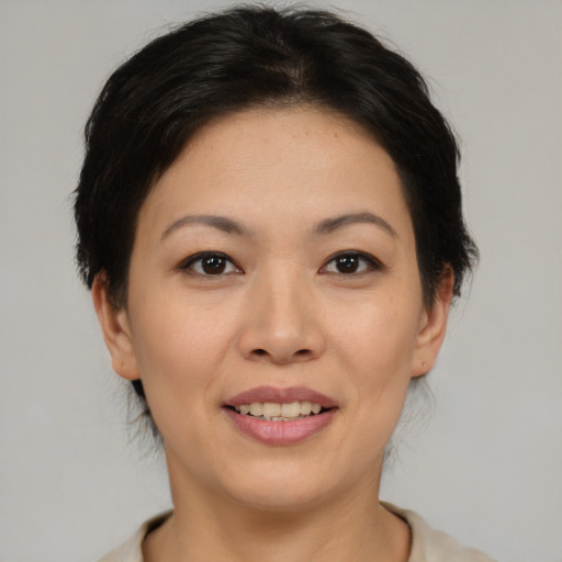 Joyful asian young-adult female with medium  brown hair and brown eyes