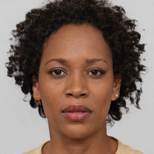 Neutral black adult female with short  black hair and brown eyes