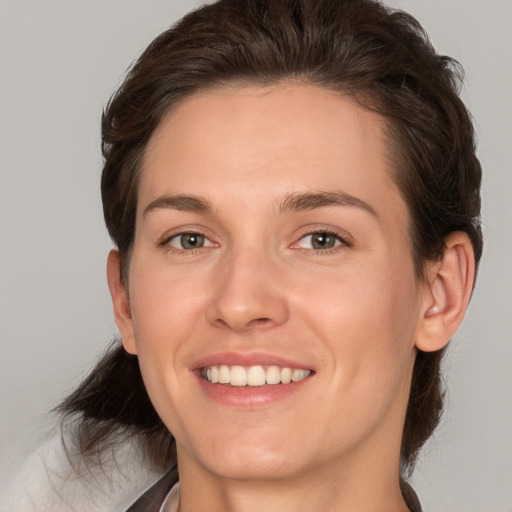 Joyful white young-adult female with medium  brown hair and brown eyes