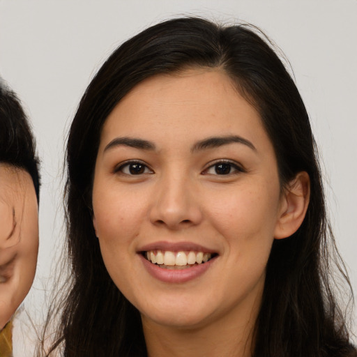 Joyful white young-adult female with long  brown hair and brown eyes