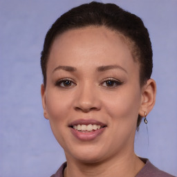 Joyful black young-adult female with short  brown hair and brown eyes