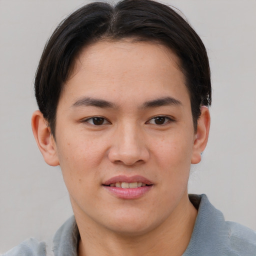 Joyful asian young-adult male with short  brown hair and brown eyes