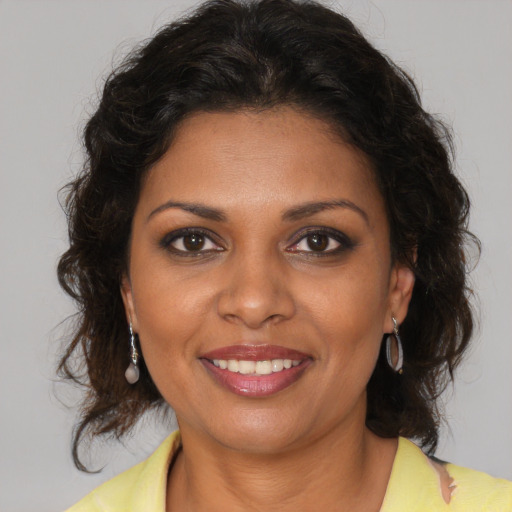 Joyful black young-adult female with medium  brown hair and brown eyes