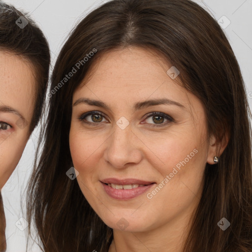 Joyful white adult female with long  brown hair and brown eyes