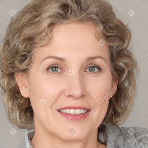 Joyful white adult female with medium  brown hair and blue eyes