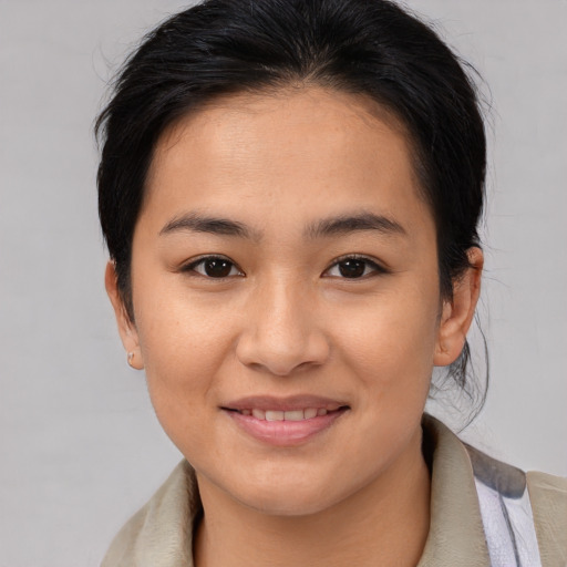Joyful asian young-adult female with medium  brown hair and brown eyes