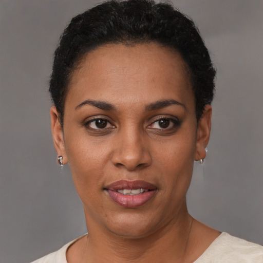 Joyful black young-adult female with short  black hair and brown eyes