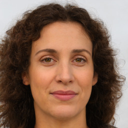 Joyful white adult female with long  brown hair and brown eyes