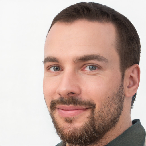 Joyful white young-adult male with short  brown hair and brown eyes