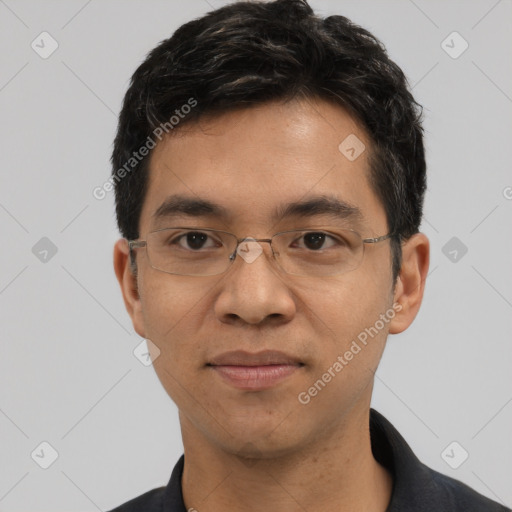 Joyful asian young-adult male with short  black hair and brown eyes