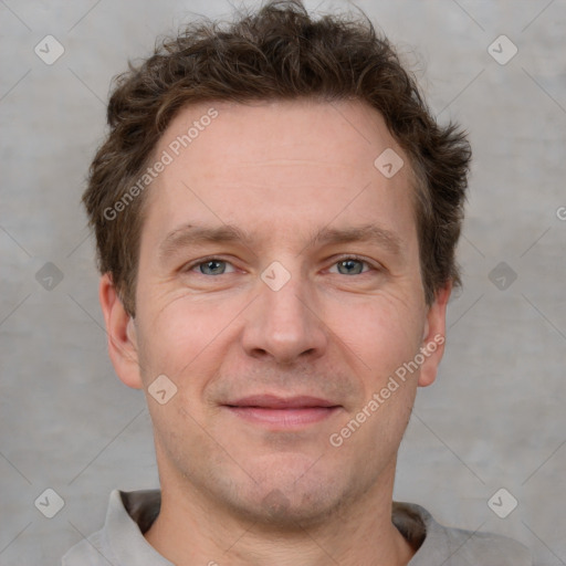 Joyful white adult male with short  brown hair and grey eyes