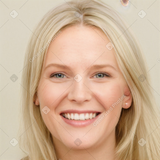 Joyful white young-adult female with long  blond hair and blue eyes