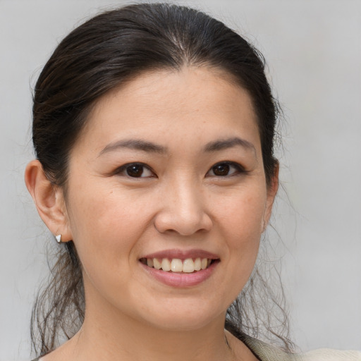 Joyful white young-adult female with medium  brown hair and brown eyes