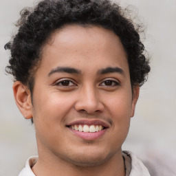 Joyful latino young-adult male with short  brown hair and brown eyes