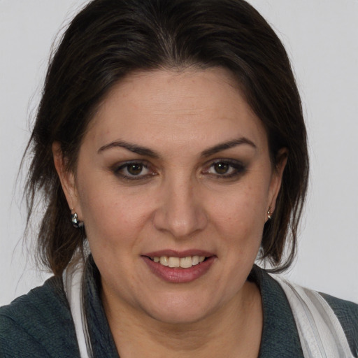 Joyful white adult female with medium  brown hair and brown eyes